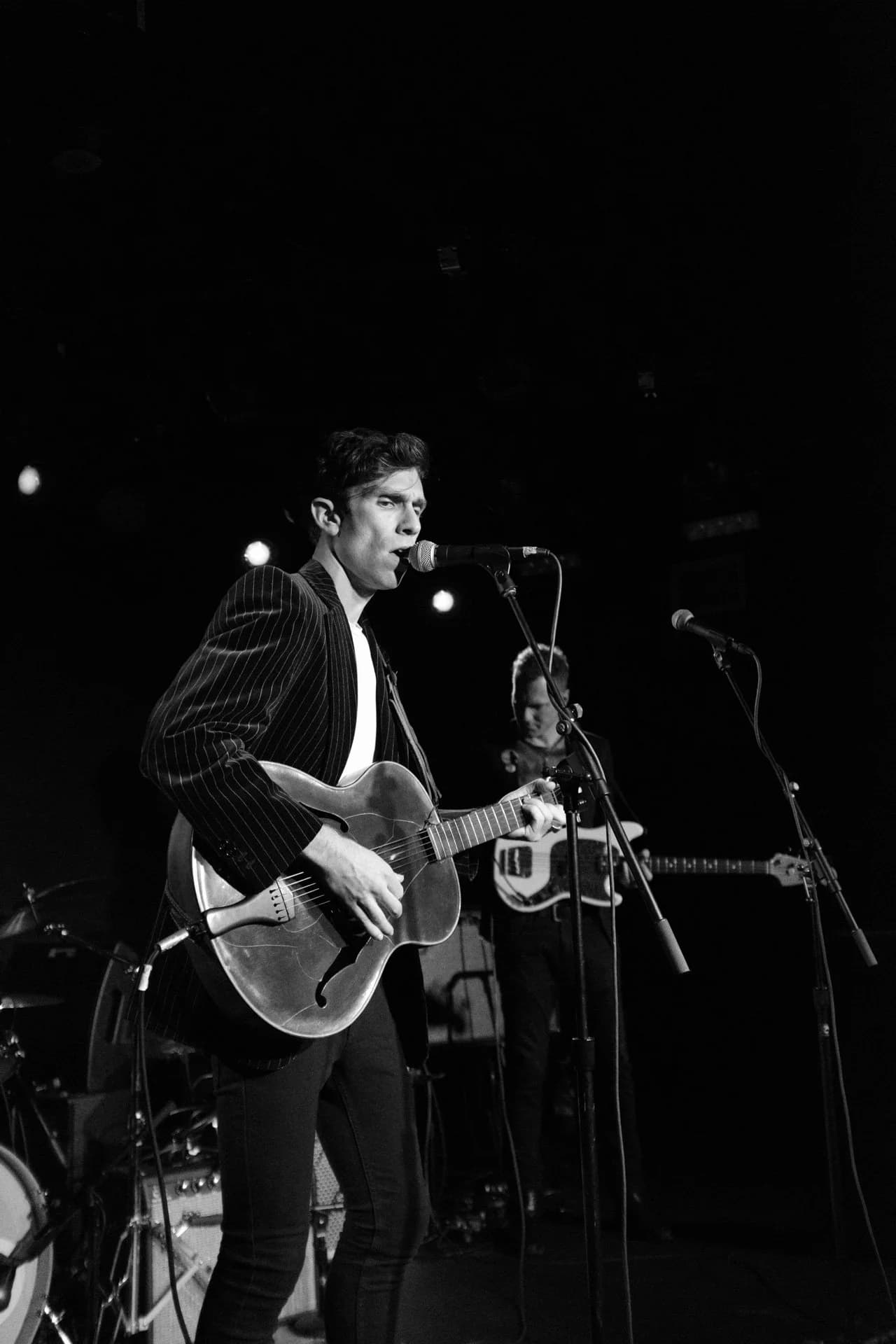 Sam Kogon performing on stage, black and white
